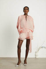 A pink mini dress with full pleats and ruffles named Eugenie