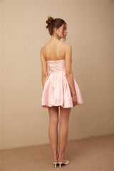 A pink mini dress with offshoulder design and puff sleeves made of satin fabric