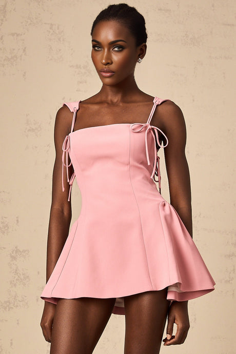 A pink mini dress with puff sleeves and a detachable strap by Donatienne featuring a short hemline and feminine silhouette