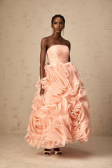 A pink offshoulder midi dress with 3D petal details made of tulle fabric The dress has a fitted bodice and flares out to a full skirt reaching midcalf length