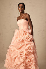 A pink offshoulder midi dress with 3D petal details on tulle fabric