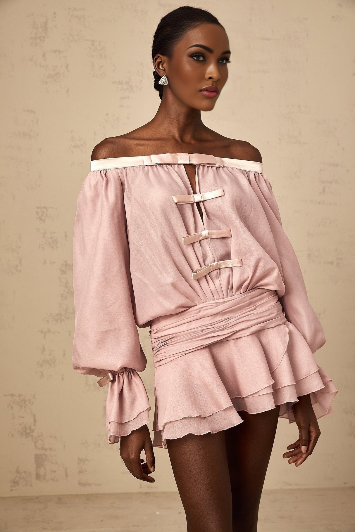 A pink offshoulder mini dress with a bow detail and flounced design named Dulcie