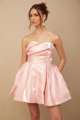 A pink satin mini dress with offshoulder neckline and puff sleeves