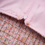 A pink tweed mini dress with embellishments named Aoife featuring a short hemline and decorative details on a textured fabric