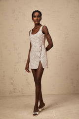 A pink tweed mini dress with embellishments named Aoife featuring a short hemline and decorative details on the fabric