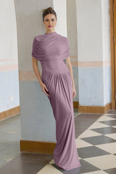 A purple asymmetric maxi dress with pleated details and a flowing silhouette worn by a model