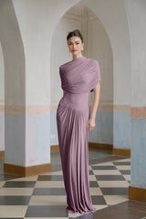A purple asymmetric maxi dress with pleated details worn by a model standing against a plain background