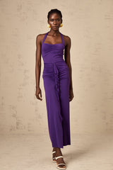 A purple halterneck midi dress with ruched detailing on a female model