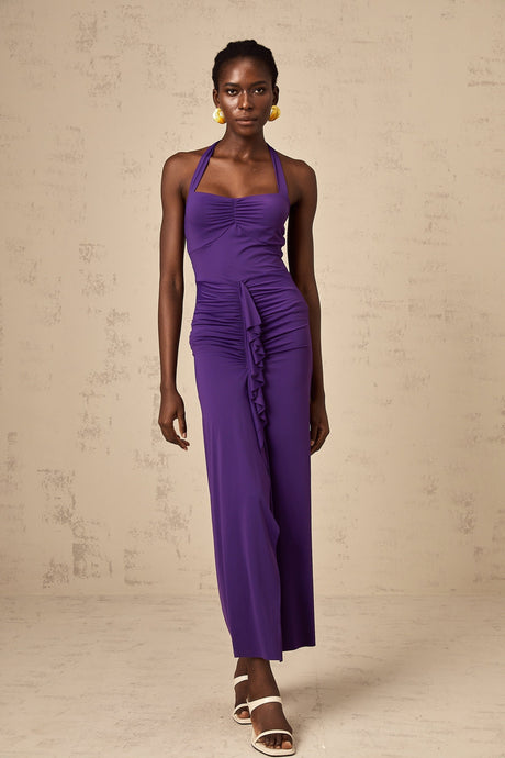 A purple halterneck midi dress with ruched detailing on a female model