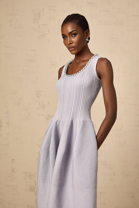 A purple ribbed knit midi dress with embellishments and a fitted silhouette