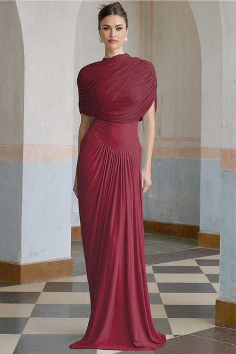 A red asymmetric maxi dress with pleats worn by a model standing against a plain background