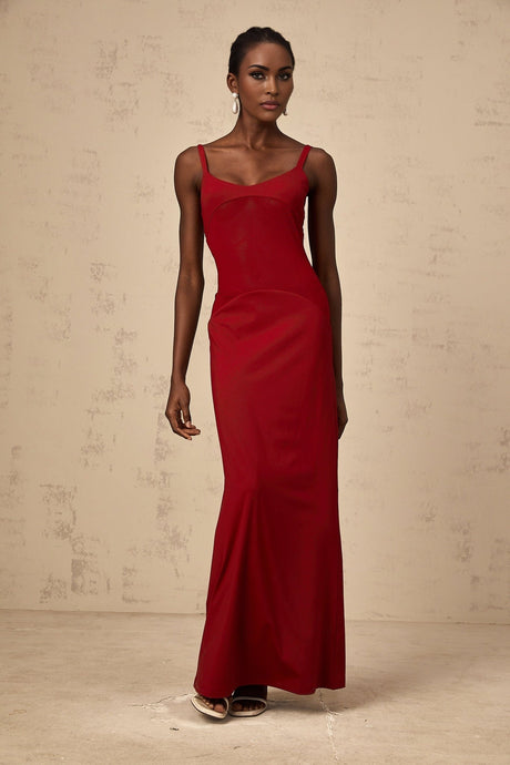A red floor length dress with sheer tulle panels designed by Celine