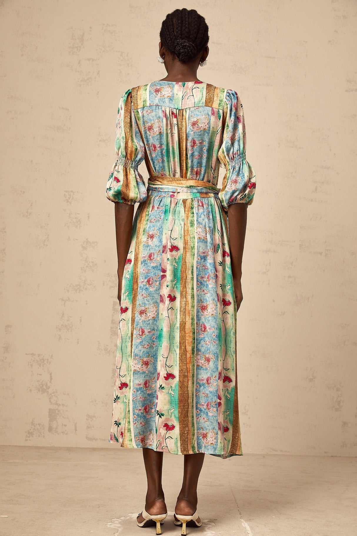 A red floral print wrap dress with a midi length skirt and short sleeves