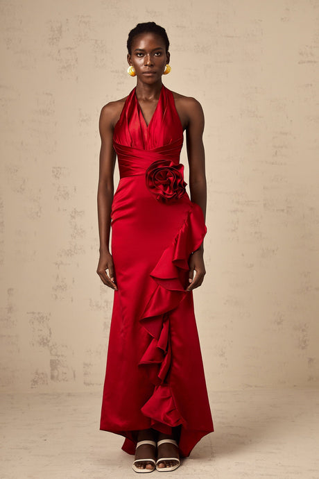 A red halterneck maxi dress with 3D petal ruffles and a long flowing skirt