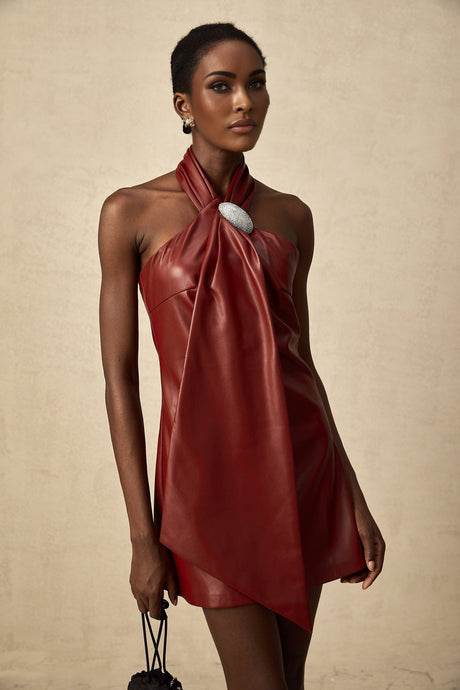 A red halterneck mini dress made of sheepskin with a sleek and formfitting silhouette