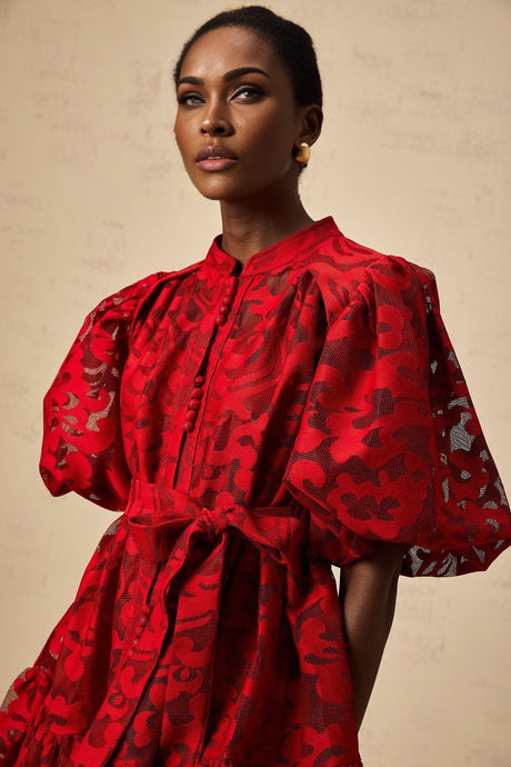 A red jacquard mini dress with a semi sheer fabric featuring a floral or intricate pattern design
