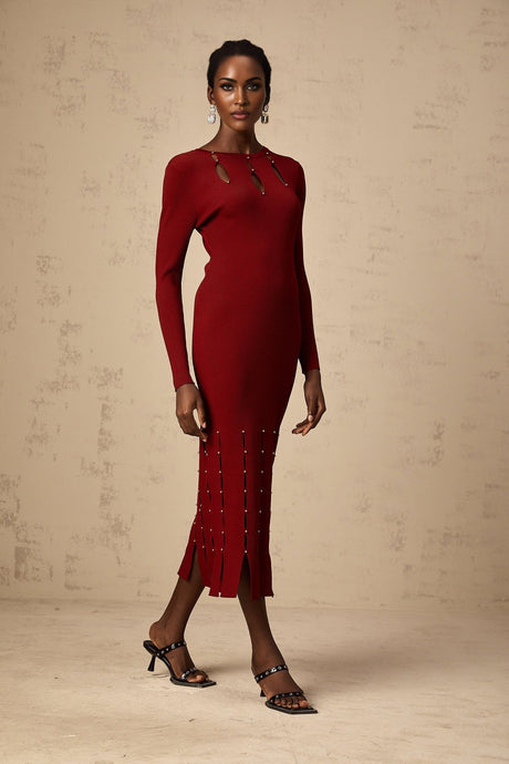 A red knit midi dress with long sleeves beaded detailing and cutout design worn by a model