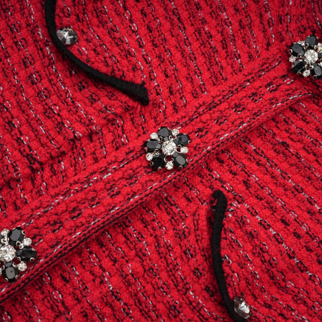 A red knitted midi dress with embellishments named Faustine featuring a form fitting silhouette and decorative details