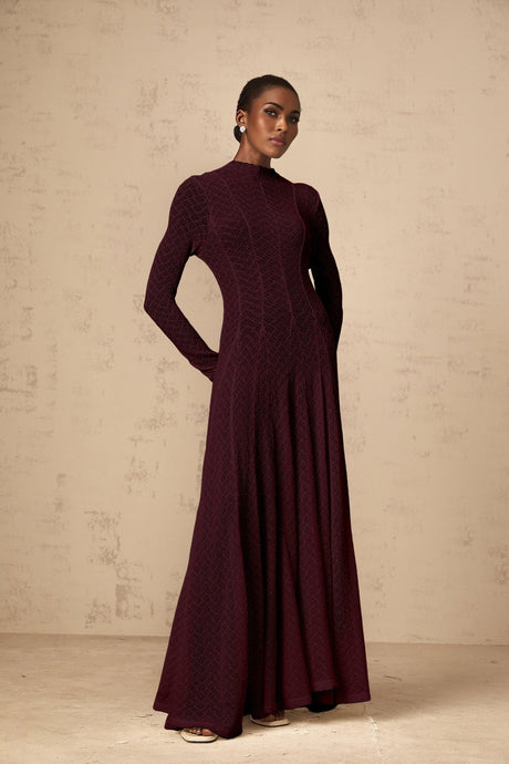 A red lace maxi dress with a wavy pattern design called Athena featuring a full length skirt and delicate lacework throughout