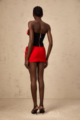 A red matching set consisting of a top and skirt featuring rose appliques named Heloise