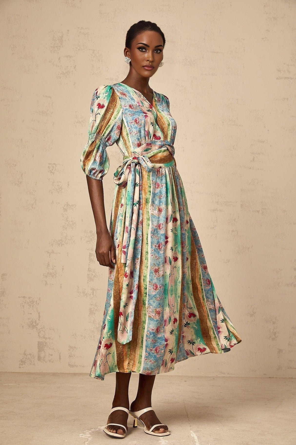A red midi dress with a floral print pattern and wrap style design
