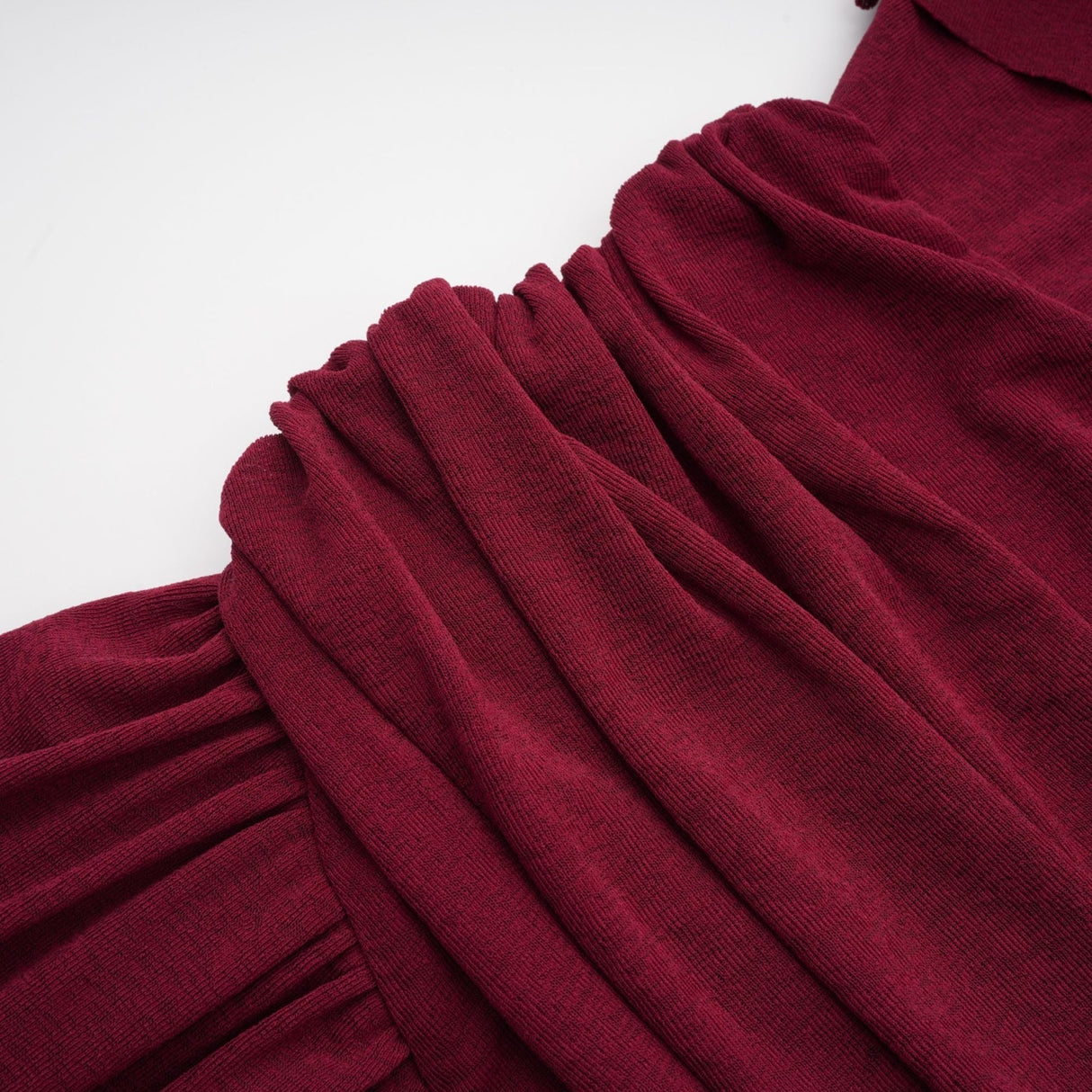 A red midi dress with ruched detailing and a flap design named Camille