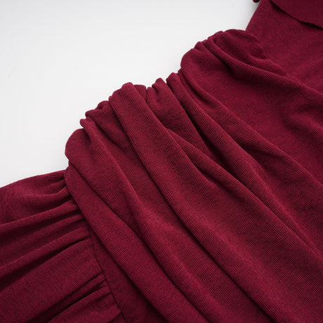 A red midi dress with ruched detailing and a flap design named Camille