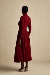 A red midi dress with ruched detailing and a flap design named Camille