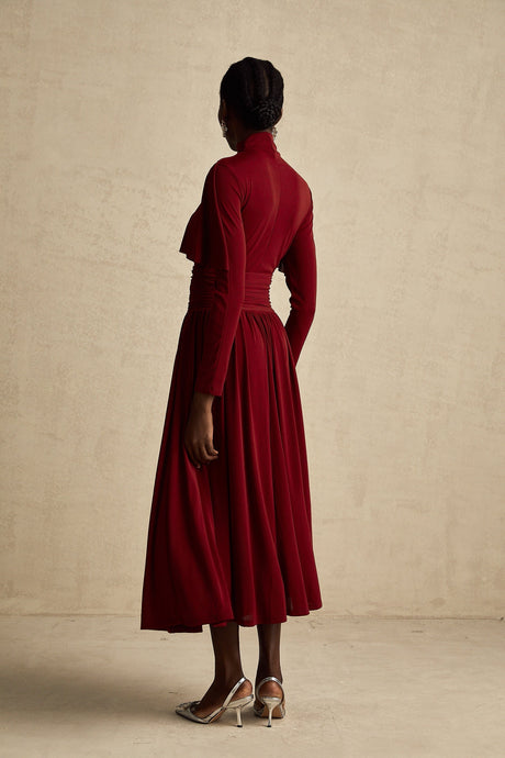 A red midi dress with ruched detailing and a flap design named Camille