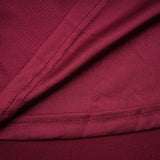 A red midi dress with ruched details and a flap design named Camille