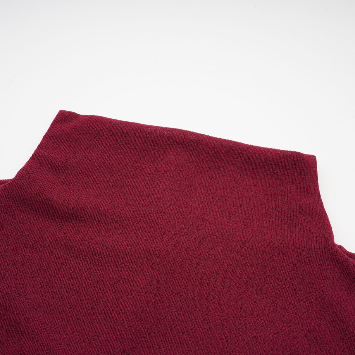 A red midi dress with ruched details and a flap design named Camille
