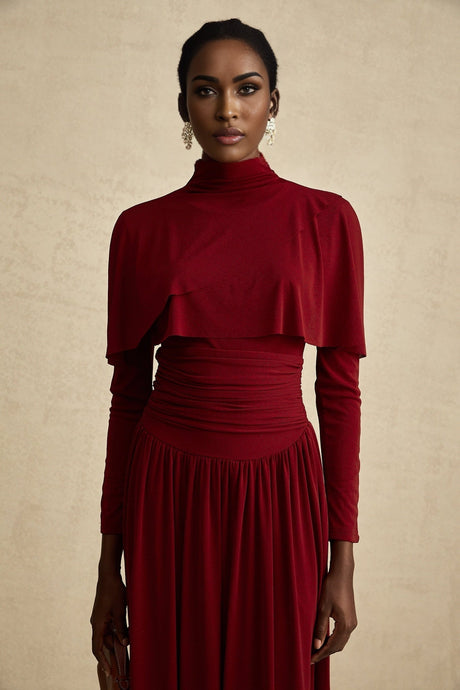 A red midi dress with ruching and a flap design named Camille