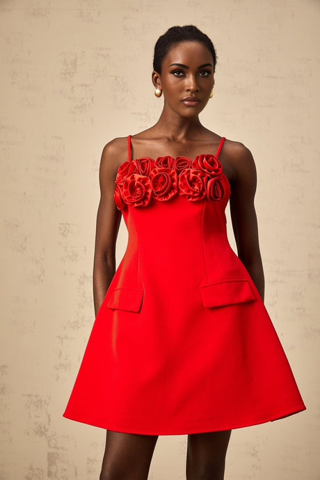 A red mini dress with a flared skirt featuring rose appliqués and a fitted bodice