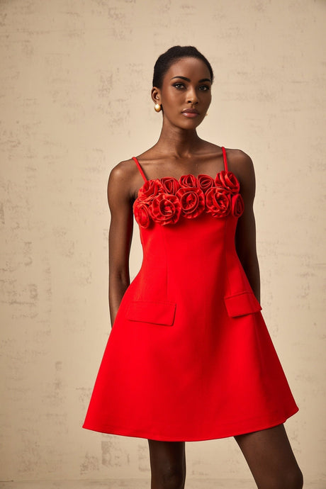 A red mini dress with a flared skirt featuring rose appliqués and a fitted bodice