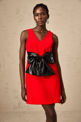 A red mini dress with a Vneckline featuring a sequin bow detail on the front