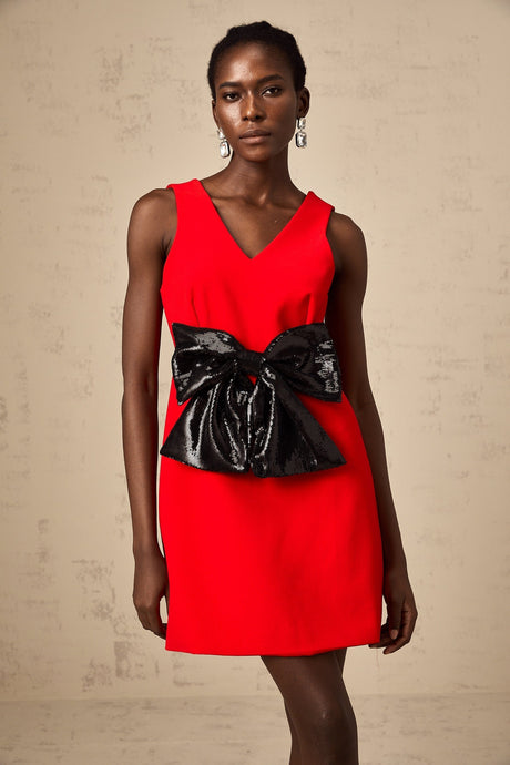 A red mini dress with a Vneckline featuring a sequin bow detail on the front