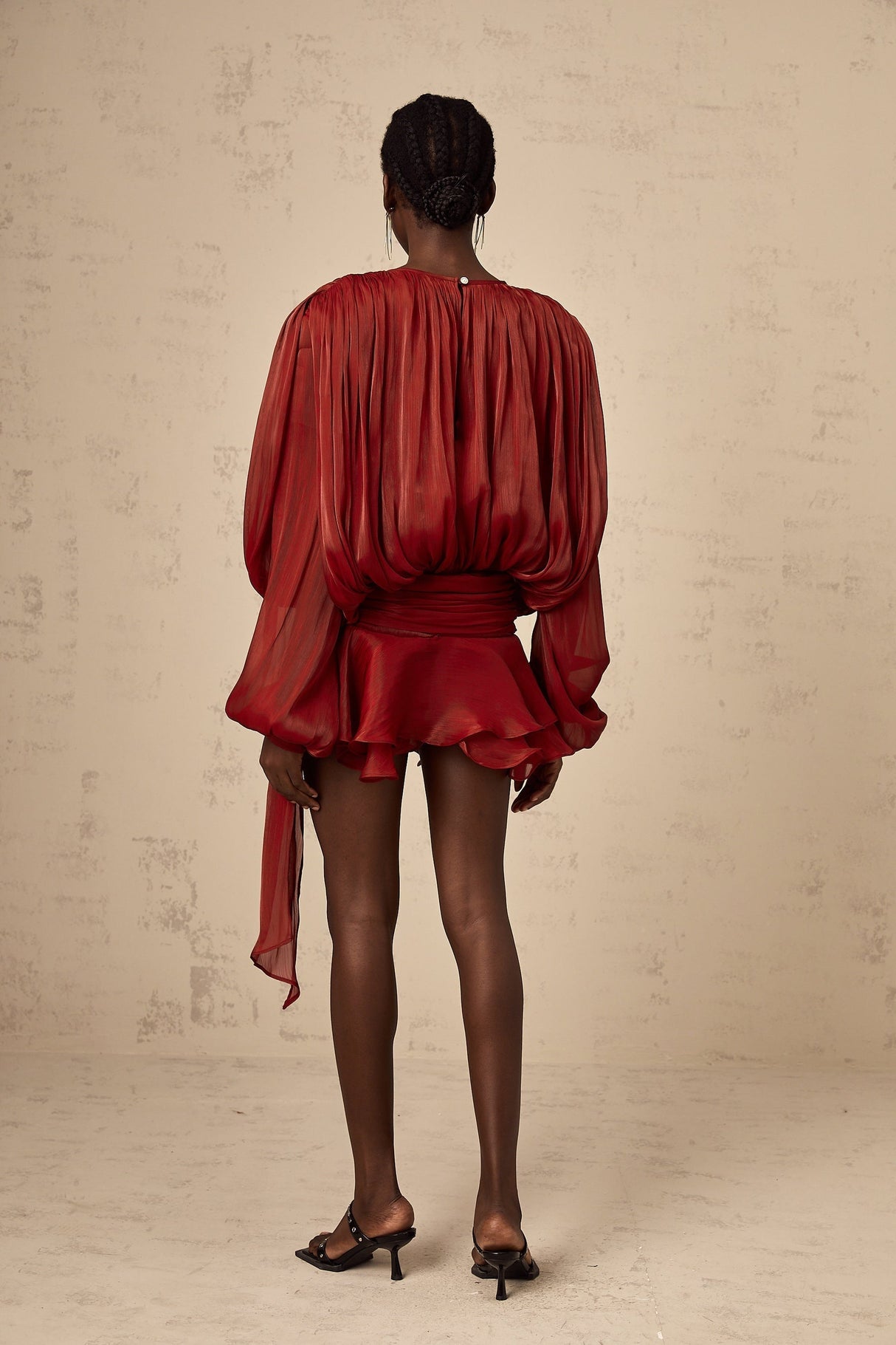 A red mini dress with full pleats and ruffles named Eugenie