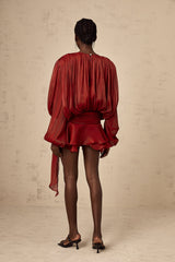 A red mini dress with full pleats and ruffles named Eugenie