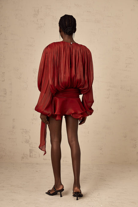 A red mini dress with full pleats and ruffles named Eugenie