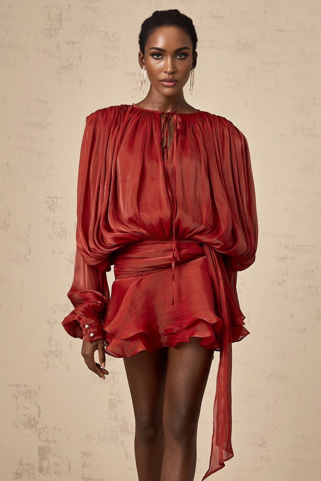 A red mini dress with full pleats and ruffles named Eugenie