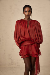 A red mini dress with full pleats and ruffles named Eugenie