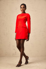 A red mini dress with long sleeves and a bow detail at the neckline The dress is called Magali and features a short hemline