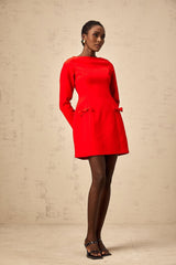 A red mini dress with long sleeves and a decorative bow detail at the neckline featuring a fitted silhouette and short hemline