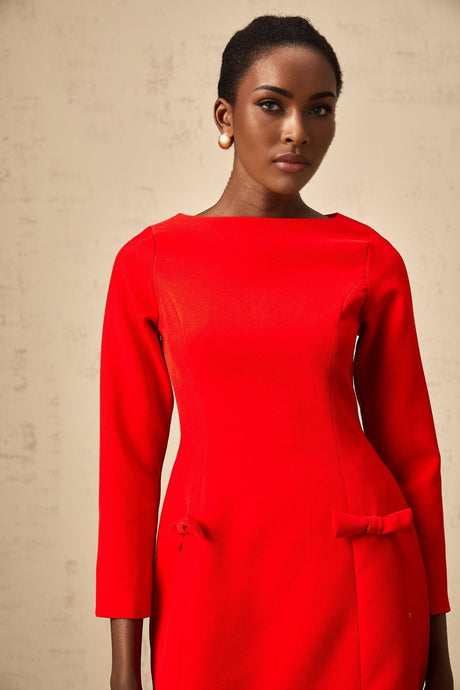 A red mini dress with long sleeves and a prominent bow detail at the neckline named Magali