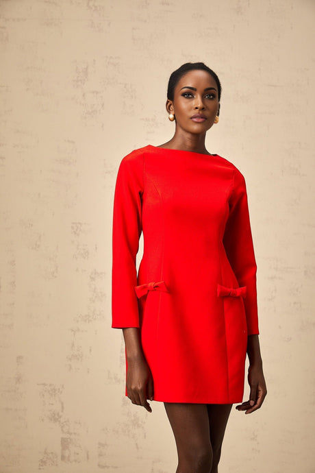 A red mini dress with long sleeves and a prominent bowknot detail