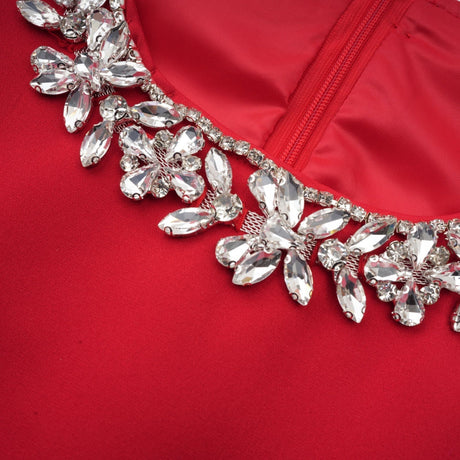 A red mini dress with pleated fabric and embellishments named Leonie