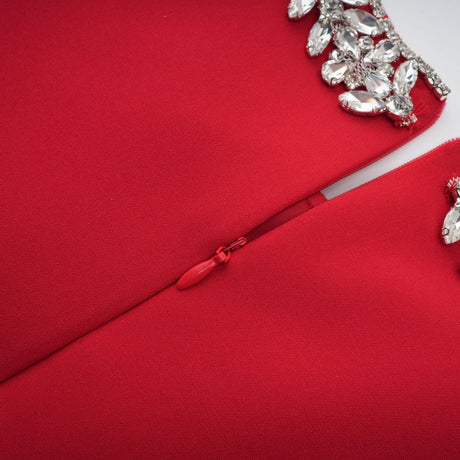 A red mini dress with pleated skirt and embellished details named Leonie