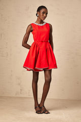 A red mini dress with pleats and embellishments named Leonie