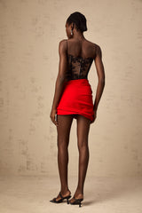 A red mini skirt with floral applique detailing and boned structure named Anne