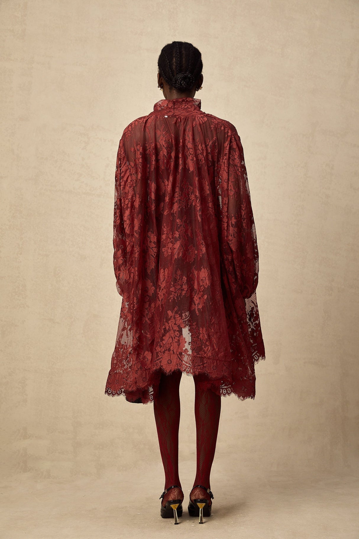 A red oversize dress made of Coline chantilly lace with a flowing silhouette and delicate floral patterns